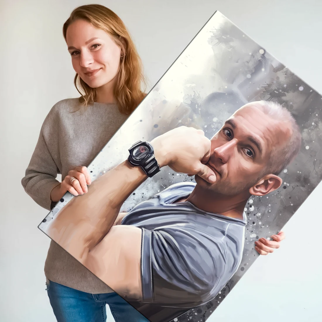 A woman holds a canvas with a man&rsquo;s portrait on a light background.